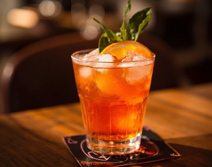 An Aperol spritz served chilled with an orange slice